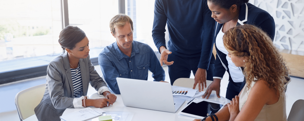 A group of people is discussing about hiring web engineering teams sitting at a table